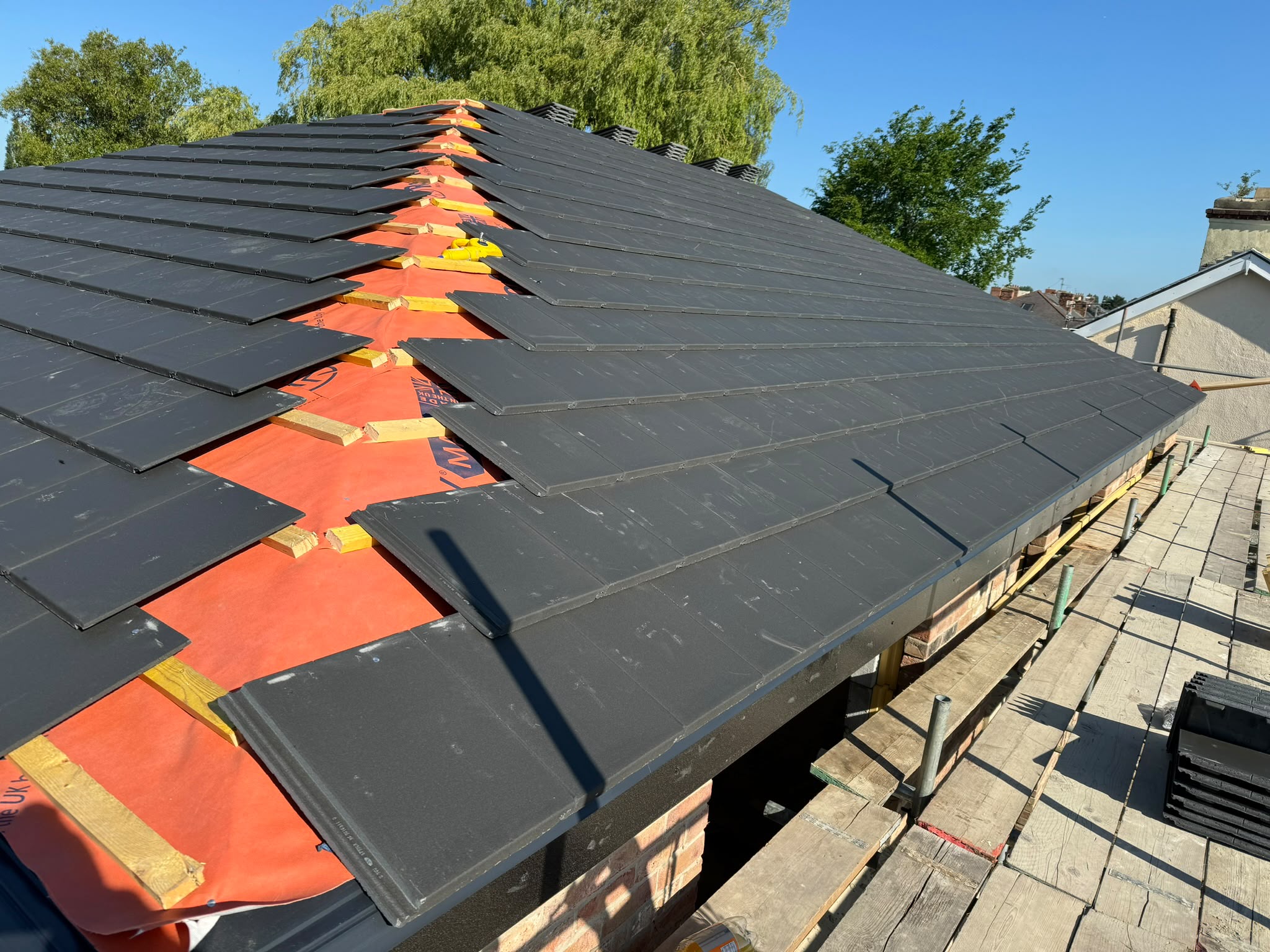 Roofers completing a new pitched roof in the North East