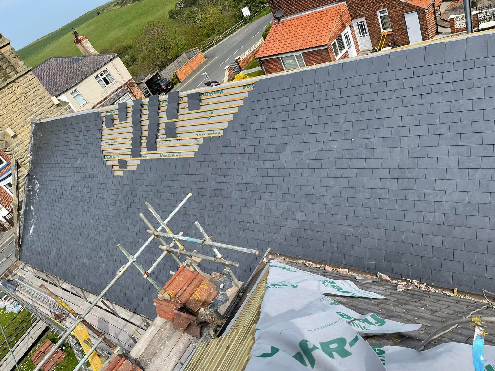 A new slate roof being installed on a property
